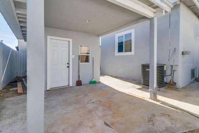 doorway to property with a patio and central air condition unit