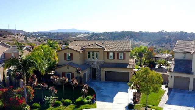 view of front facade featuring a garage and a mountain view