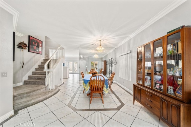 dining area with light tile patterned flooring, an inviting chandelier, and ornamental molding