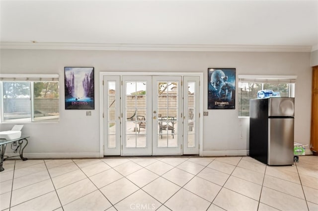 doorway featuring light tile patterned floors, french doors, and crown molding