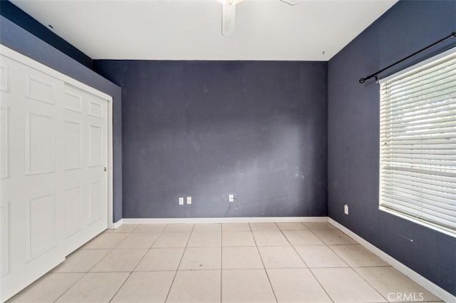 unfurnished bedroom with ceiling fan and light tile patterned floors