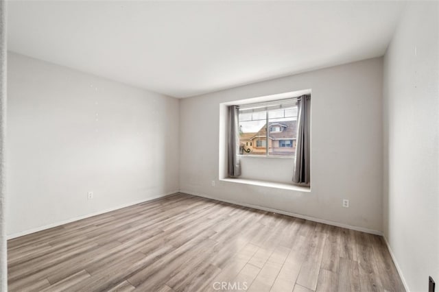 spare room with light wood-type flooring