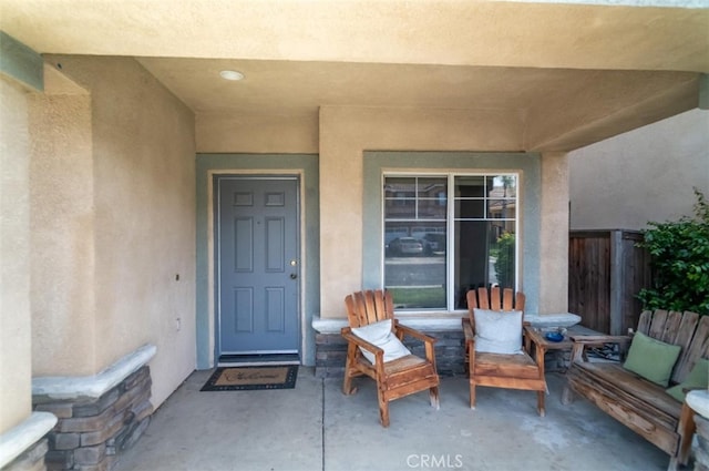 property entrance featuring a patio area