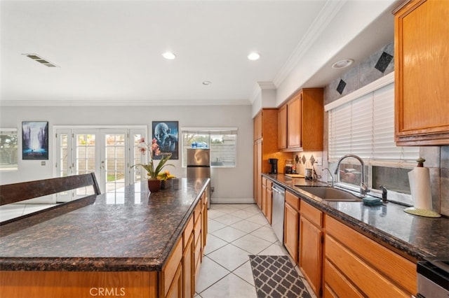 kitchen with dishwasher, a kitchen island, french doors, sink, and crown molding