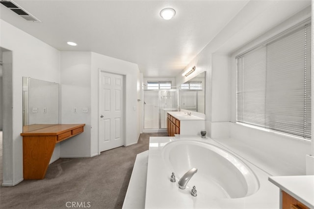 bathroom featuring separate shower and tub and vanity