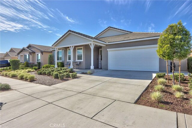 single story home with covered porch and a garage