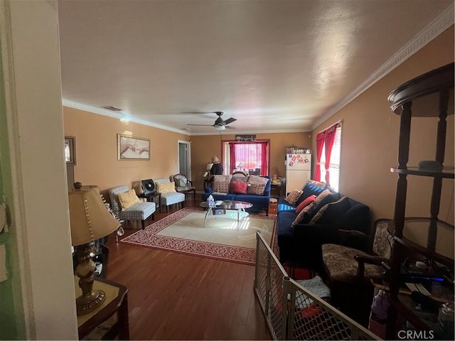 living room with ceiling fan, wood-type flooring, and ornamental molding