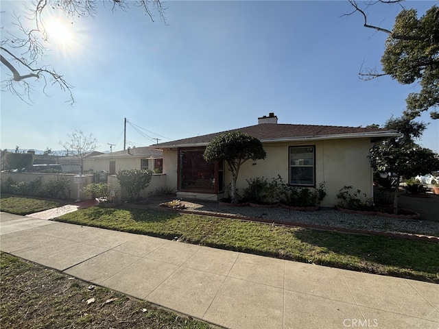 ranch-style house with a front lawn