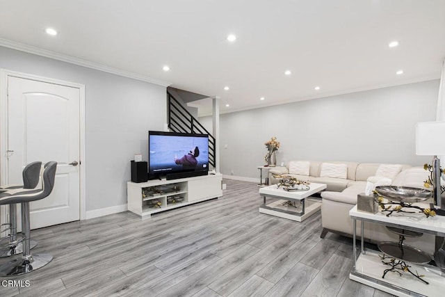 living room featuring light wood-type flooring and ornamental molding