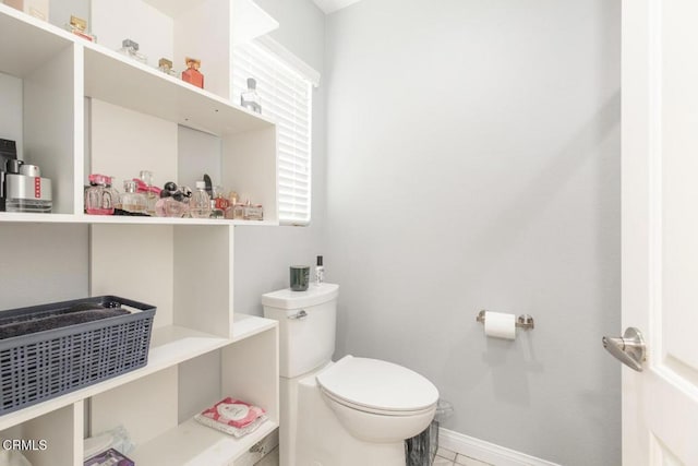 bathroom with tile patterned flooring and toilet