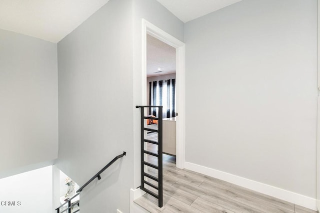 staircase with hardwood / wood-style floors