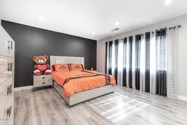 bedroom with light hardwood / wood-style flooring