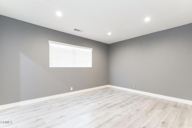 spare room featuring light wood-type flooring