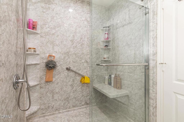 bathroom with a shower with door