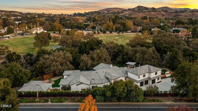 aerial view at dusk featuring a mountain view