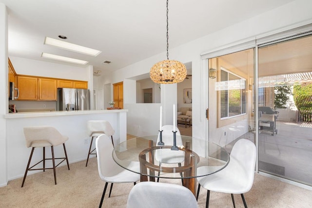 dining room with light colored carpet