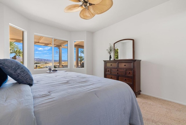 bedroom with light carpet and ceiling fan