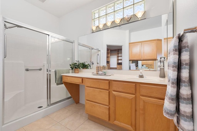 bathroom featuring tile patterned floors, vanity, and an enclosed shower