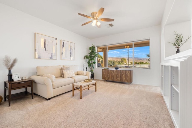 carpeted living room featuring ceiling fan