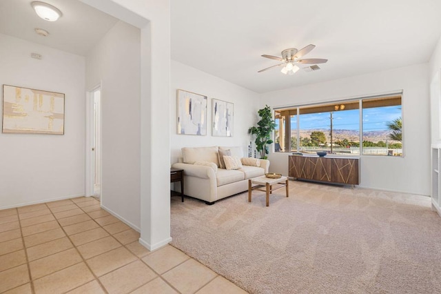 carpeted living room featuring ceiling fan