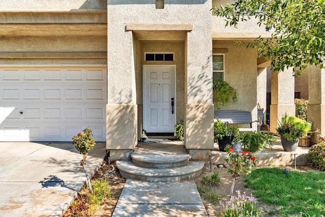 view of exterior entry with a garage