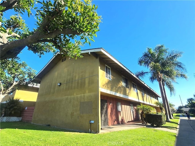 view of property exterior with a lawn