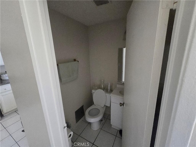 bathroom featuring vanity, toilet, and tile patterned flooring