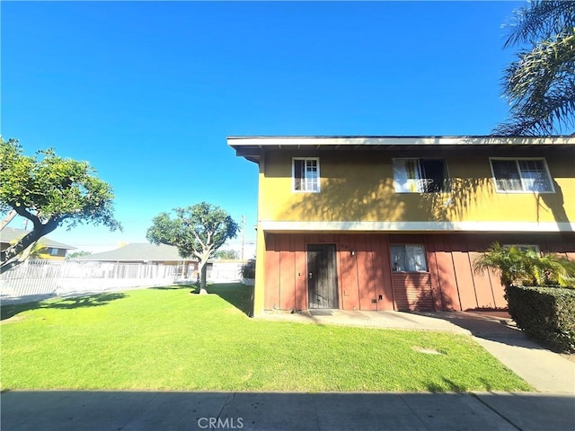 rear view of house featuring a lawn