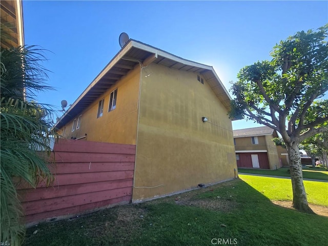 view of property exterior with a yard