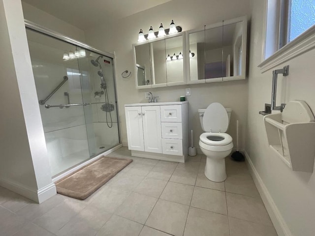 bathroom with toilet, vanity, tile patterned floors, and an enclosed shower