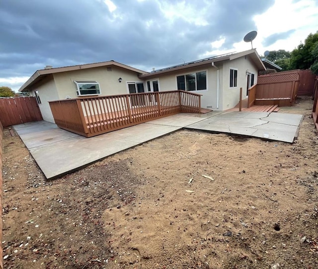 rear view of house with a patio area and a deck