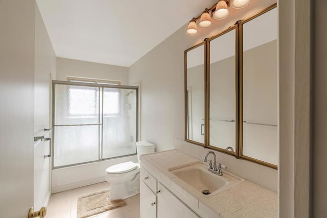 full bathroom featuring tile patterned flooring, vanity, toilet, and enclosed tub / shower combo