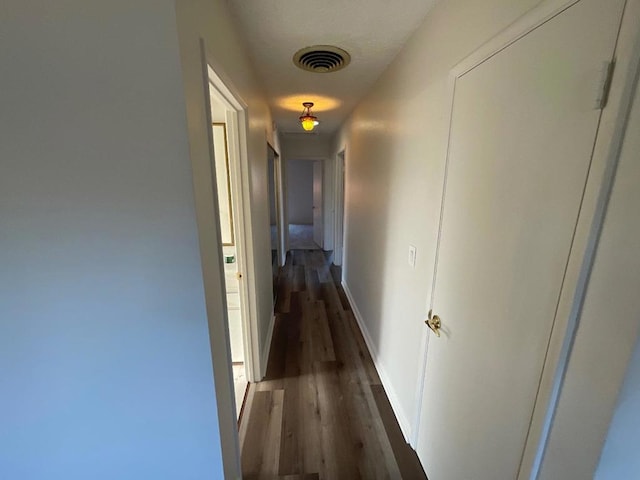 hallway with dark hardwood / wood-style floors