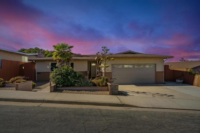 ranch-style house featuring a garage