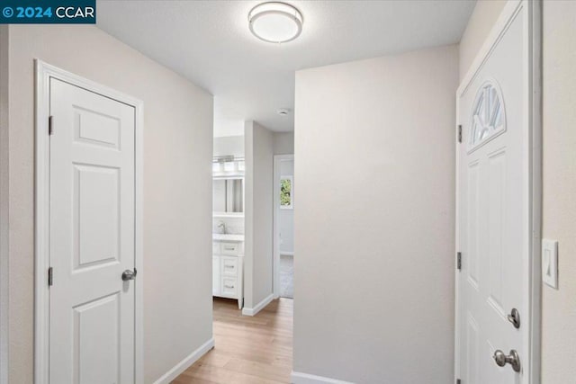 hallway with light wood-type flooring