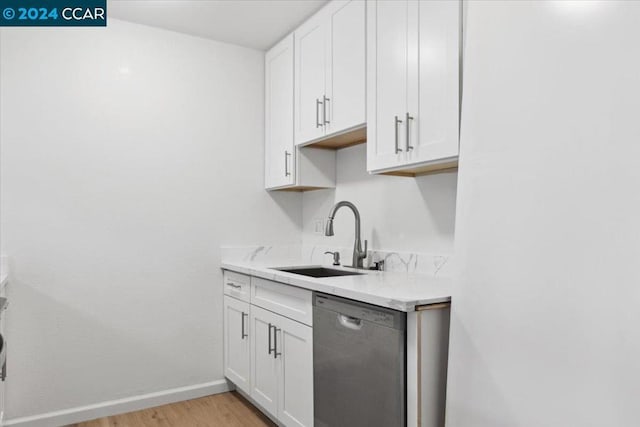 kitchen with dishwasher, light hardwood / wood-style floors, white cabinetry, and sink