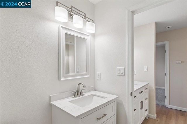 bathroom featuring hardwood / wood-style floors and vanity