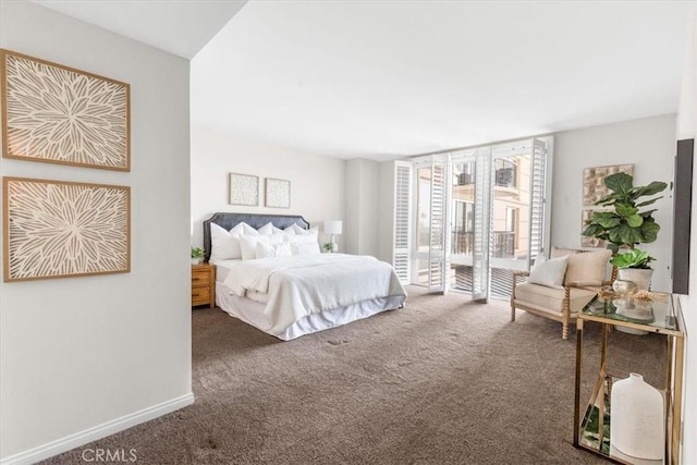 bedroom featuring access to outside, expansive windows, dark carpet, and baseboards