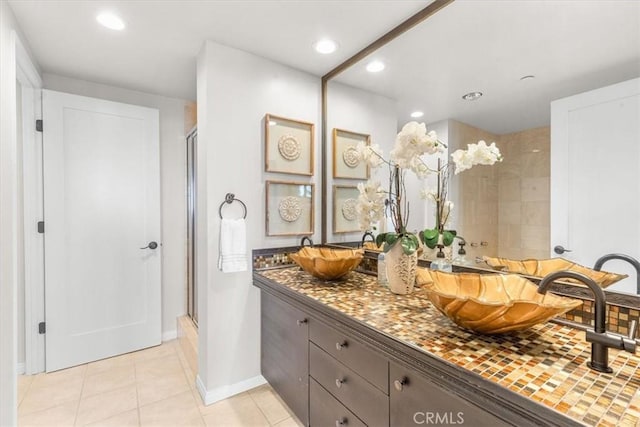 full bathroom with recessed lighting, a sink, a shower stall, tile patterned floors, and double vanity