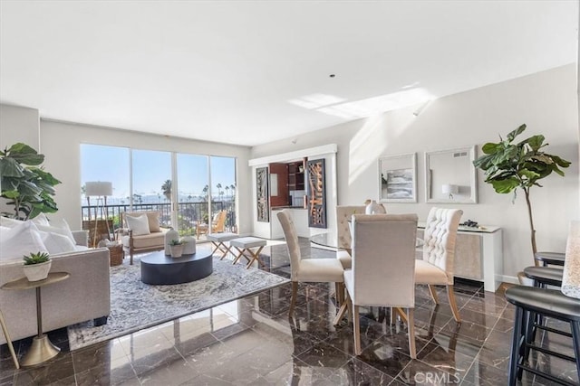 dining space featuring marble finish floor and baseboards