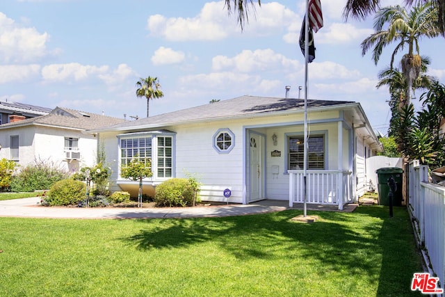 view of front of home with covered porch and a front lawn