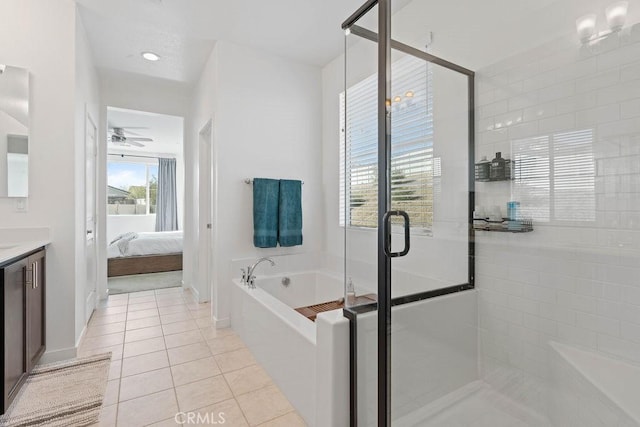 bathroom featuring tile patterned flooring, ceiling fan, separate shower and tub, and vanity