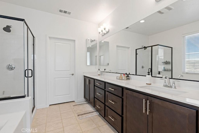 bathroom featuring tile patterned floors, vanity, and a shower with shower door