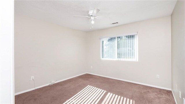 unfurnished room with light colored carpet and ceiling fan