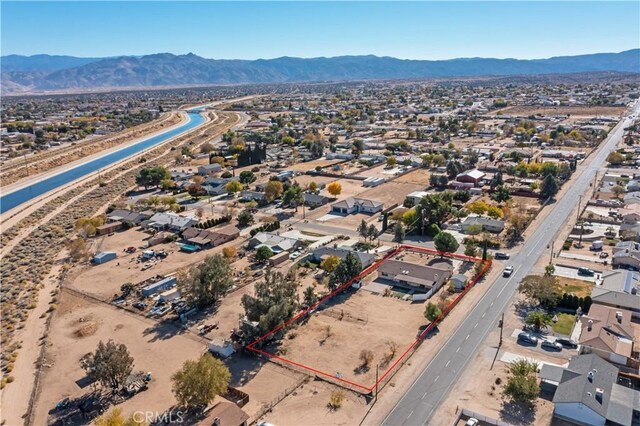 birds eye view of property with a mountain view