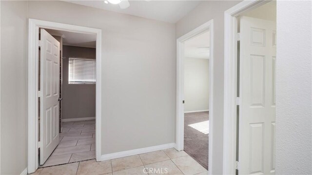 hall with light tile patterned floors