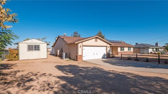 ranch-style house with solar panels and central air condition unit