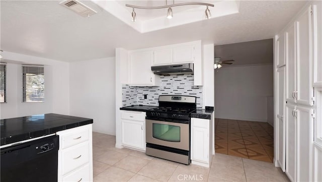 kitchen with black dishwasher, stainless steel gas range, a raised ceiling, and white cabinets