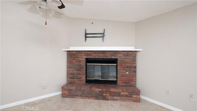 room details featuring a brick fireplace, a textured ceiling, and ceiling fan