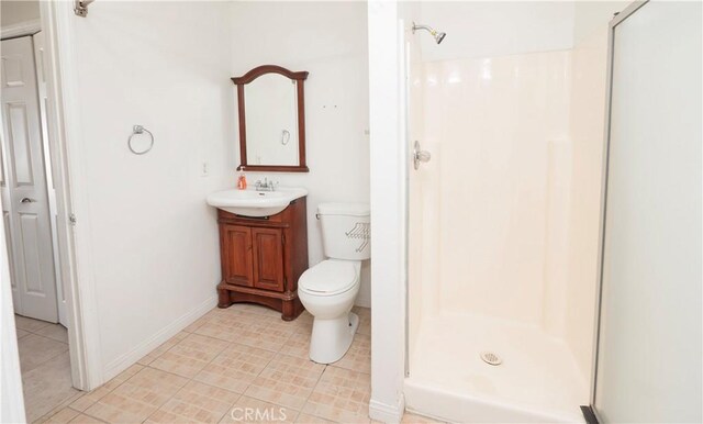 bathroom with vanity, toilet, and a shower